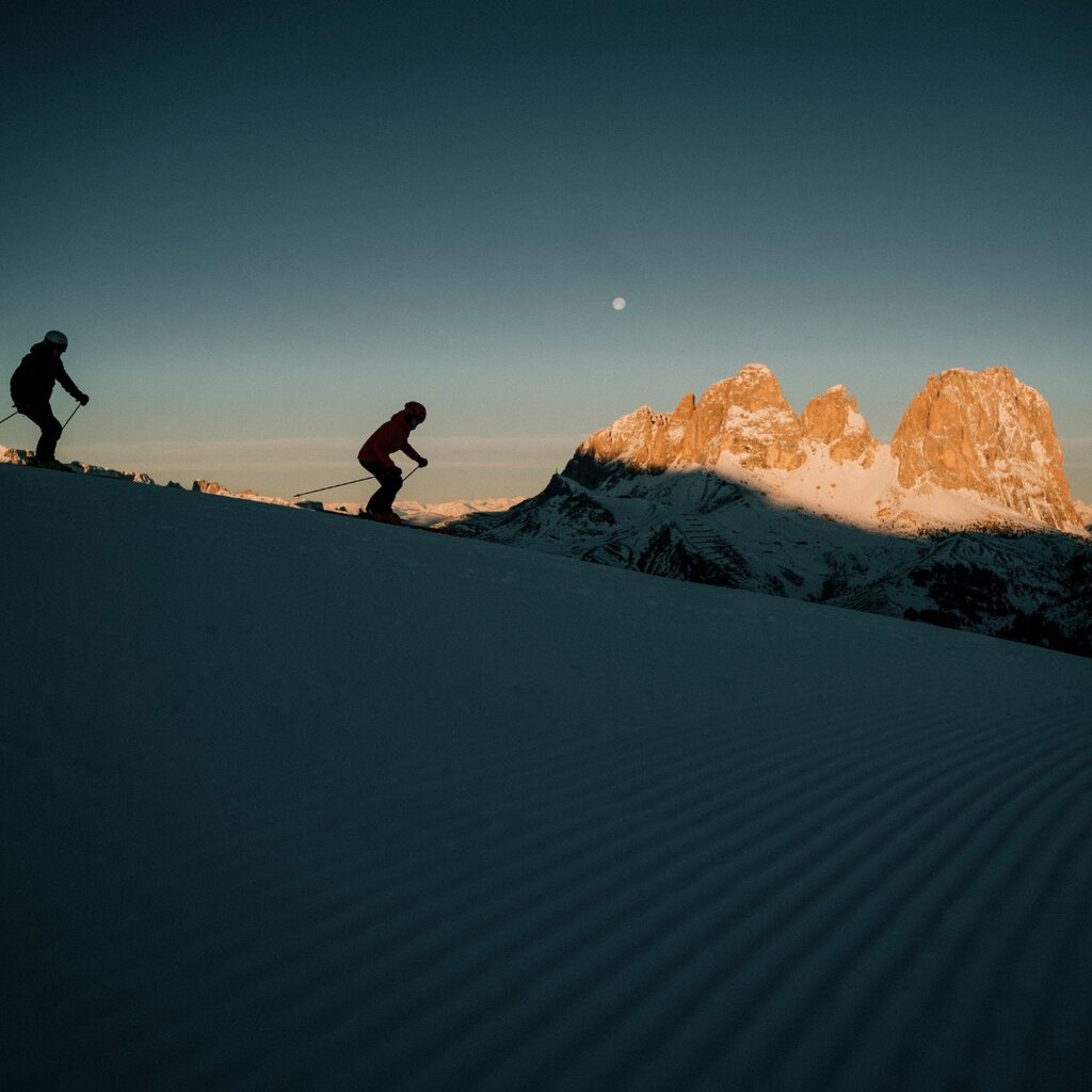 Coppia scia all'alba in Val di Fassa con vista sul Sassolungo | © Archivio immagini ApT Val di Fassa - Federico Modica