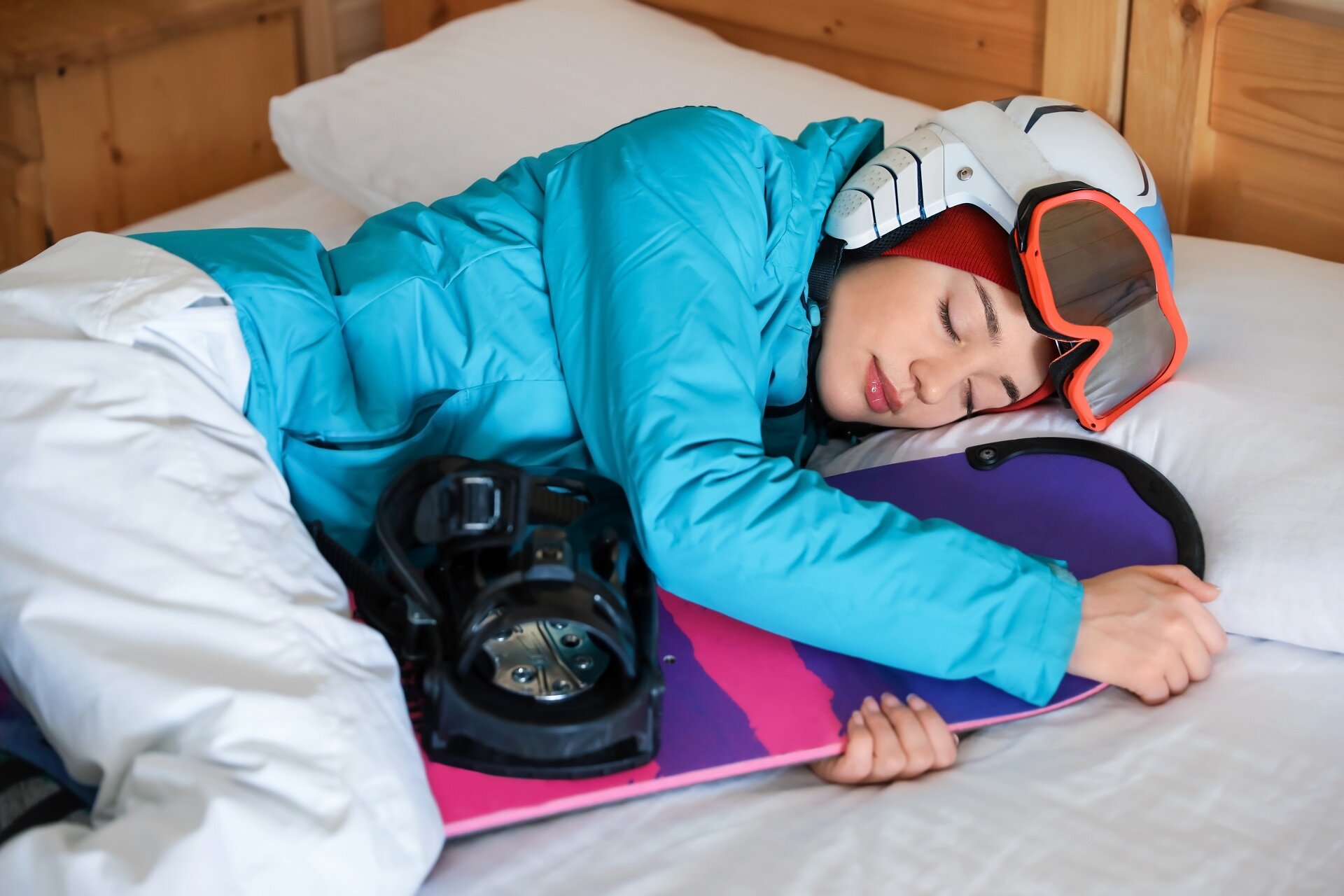 Ragazza che dorme abbracciando uno snowboard | © Archivio Immagini Val di Fassa