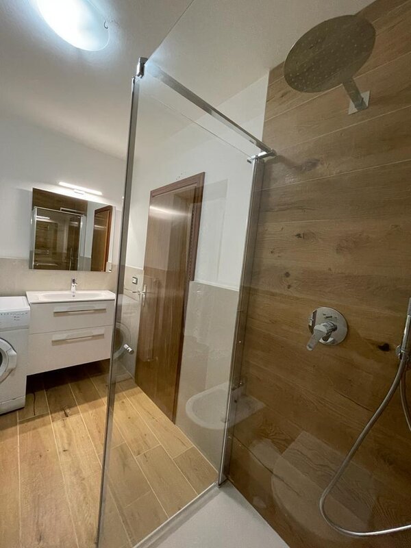 bathroom with shower and washing machine